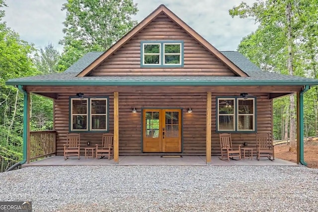 back of house with ceiling fan, french doors, and a porch