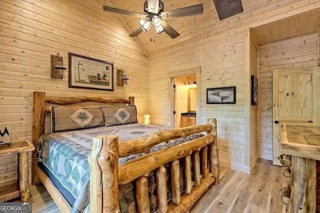 bedroom featuring wood ceiling, wooden walls, ceiling fan, high vaulted ceiling, and light hardwood / wood-style flooring