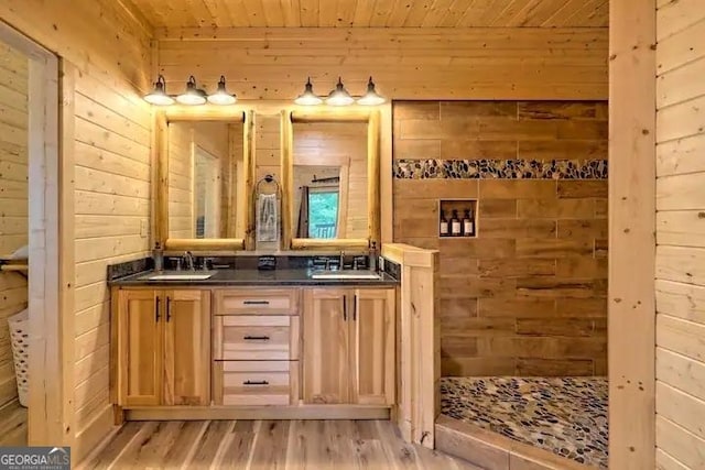 bathroom with walk in shower, vanity, wood walls, hardwood / wood-style floors, and wooden ceiling