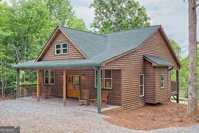 rear view of property with a patio area and a porch