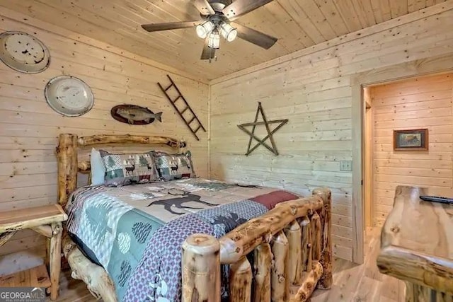 bedroom with wooden ceiling, wooden walls, and ceiling fan