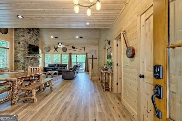 dining space featuring wooden ceiling, a healthy amount of sunlight, light hardwood / wood-style floors, and ceiling fan with notable chandelier