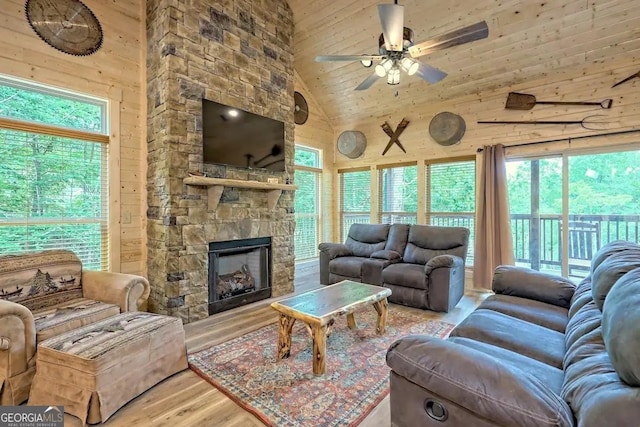 living room with high vaulted ceiling, wood ceiling, and wooden walls