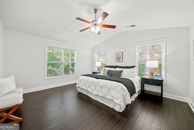 bedroom featuring multiple windows, ceiling fan, dark hardwood / wood-style flooring, and vaulted ceiling