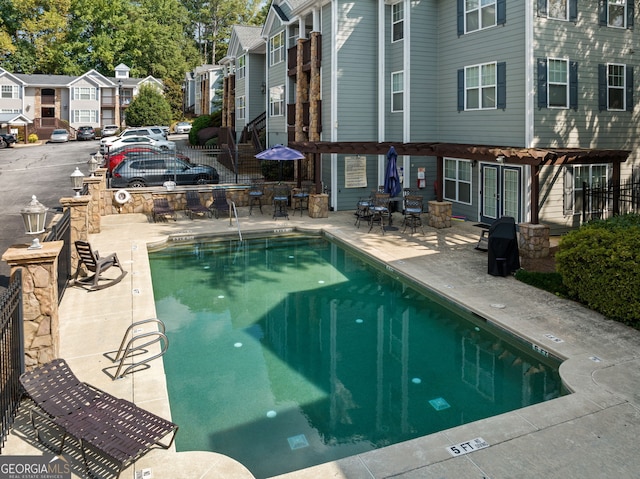 view of swimming pool featuring a pergola and a patio