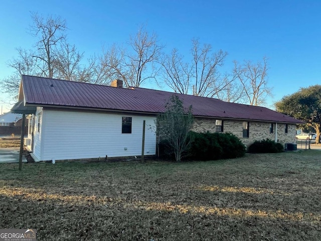 back of property featuring a yard