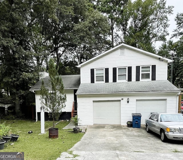 view of front of property featuring a front yard and a garage