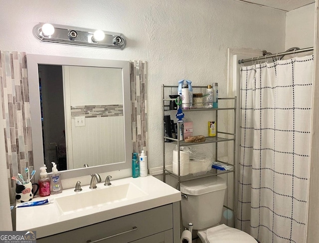 bathroom with toilet, vanity, and a shower with shower curtain