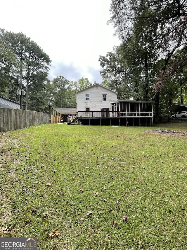 view of yard featuring a wooden deck and a sunroom