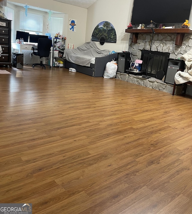 bedroom featuring a fireplace and hardwood / wood-style floors