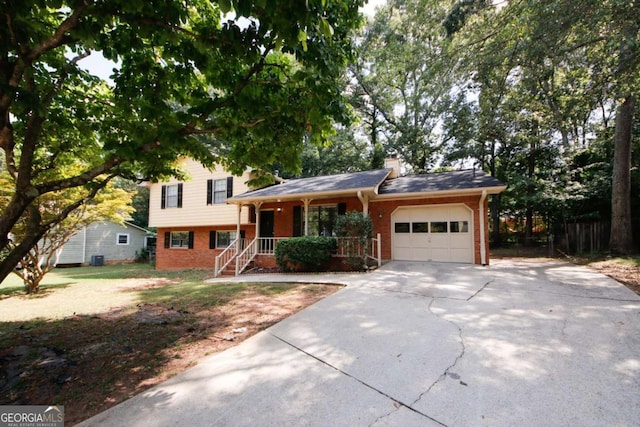 tri-level home with a porch and a garage