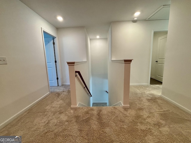 hallway featuring light colored carpet