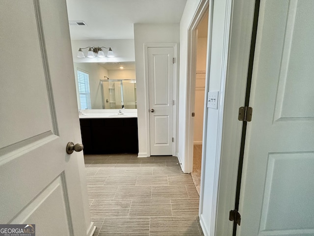 bathroom featuring vanity and a shower with shower door