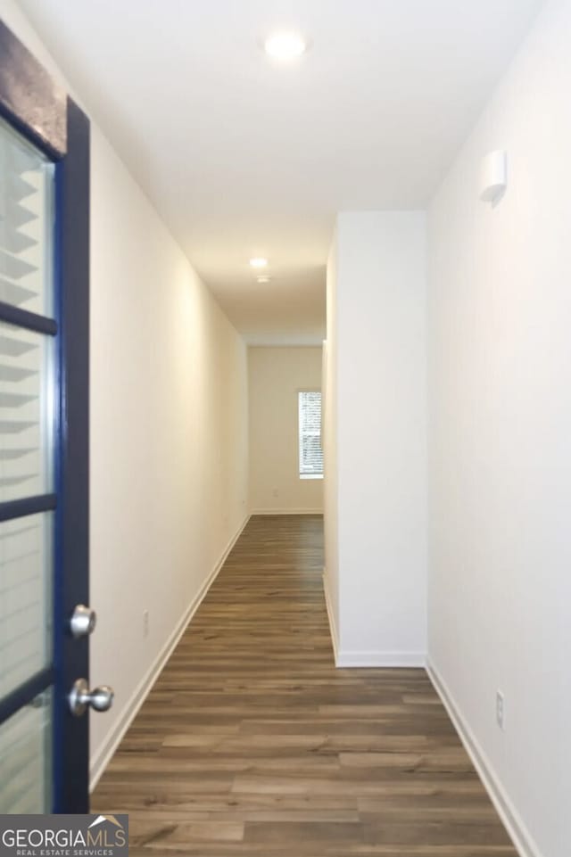 hall with dark wood-type flooring