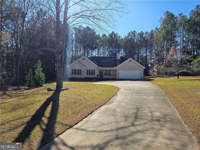 single story home featuring a garage and a front yard