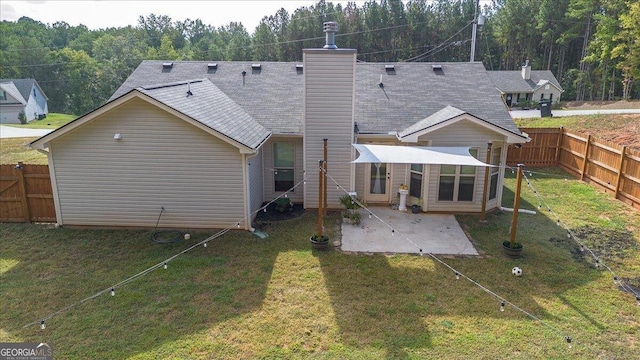 rear view of house featuring a yard and a patio