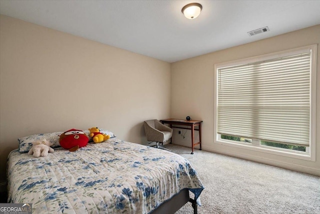 bedroom featuring carpet flooring and multiple windows