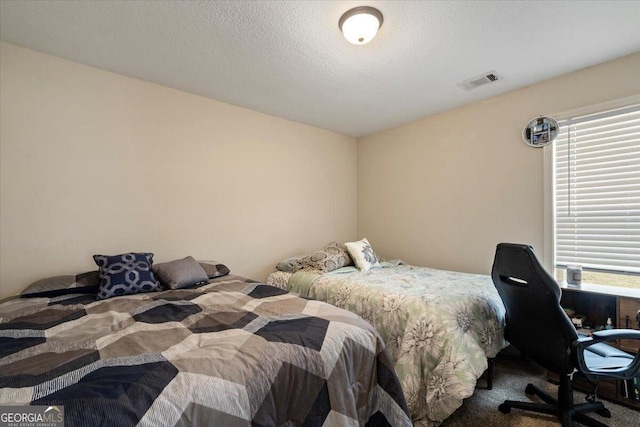 carpeted bedroom with a textured ceiling