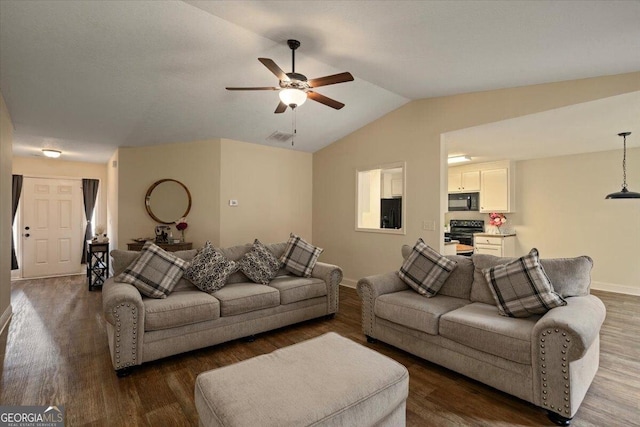 living room with lofted ceiling, ceiling fan, and dark wood-type flooring