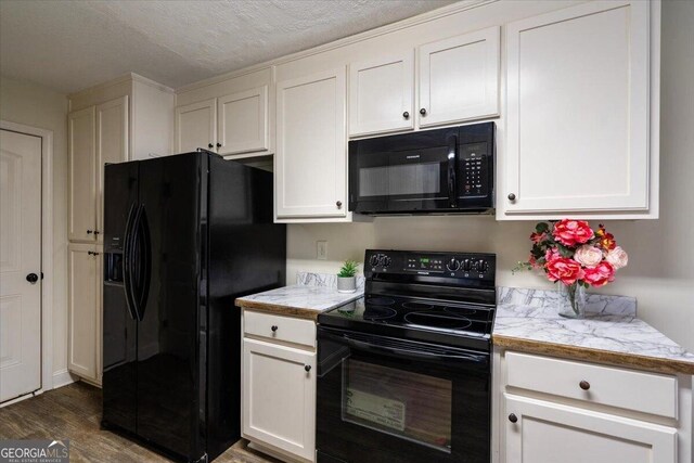 kitchen featuring a textured ceiling, dark hardwood / wood-style floors, white cabinetry, and black appliances