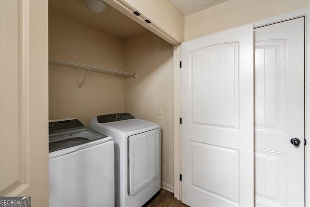 clothes washing area featuring washing machine and dryer and a textured ceiling