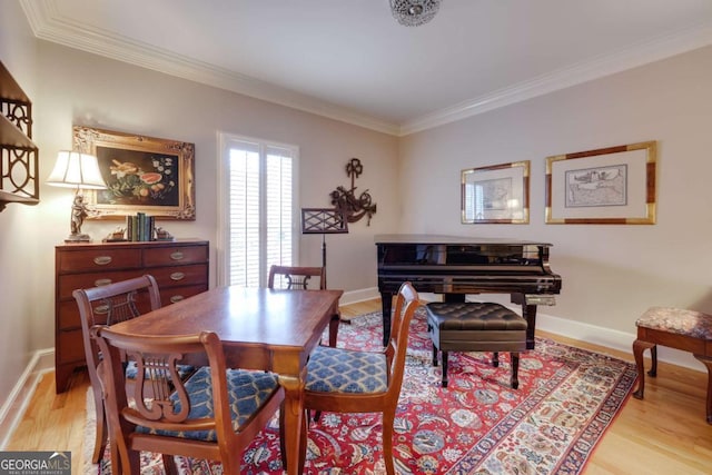 dining space featuring crown molding and light wood-type flooring