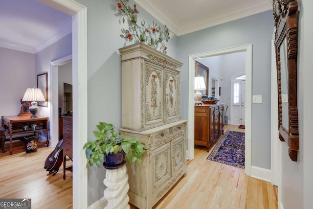 hallway featuring light wood-type flooring and crown molding