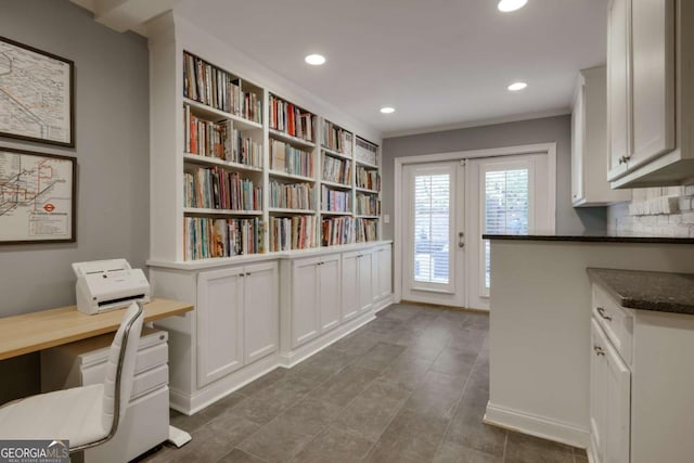 unfurnished office featuring french doors and ornamental molding