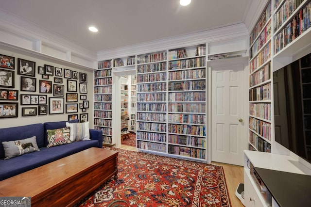 living area featuring crown molding and hardwood / wood-style floors