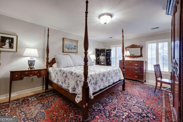 bedroom with crown molding and hardwood / wood-style floors