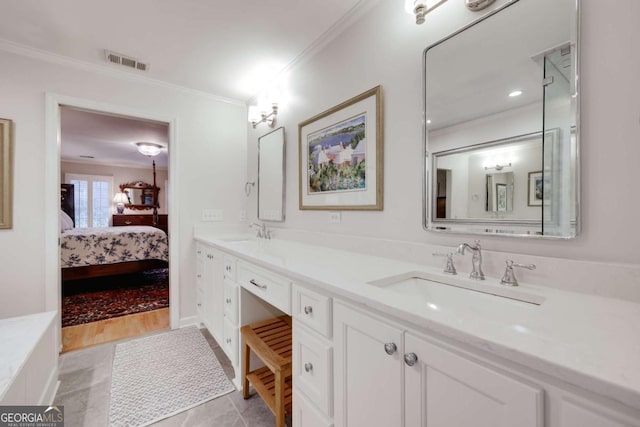 bathroom featuring tile patterned flooring, vanity, and ornamental molding