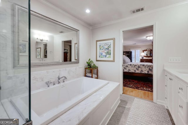 bathroom with a washtub, vanity, tile patterned floors, and crown molding