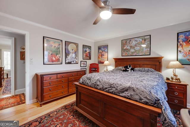 bedroom with light wood-type flooring, ceiling fan, and ornamental molding