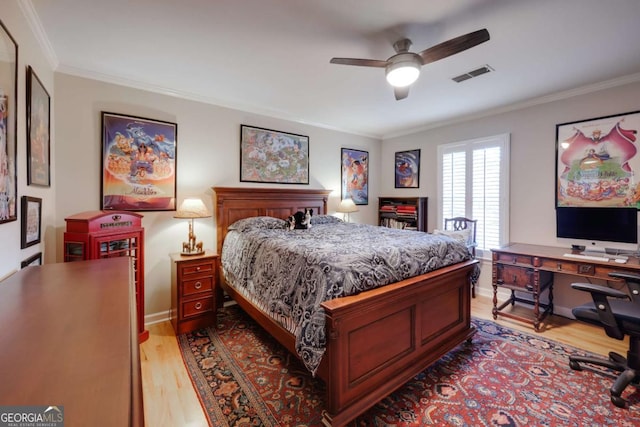 bedroom featuring light hardwood / wood-style floors, ceiling fan, and crown molding