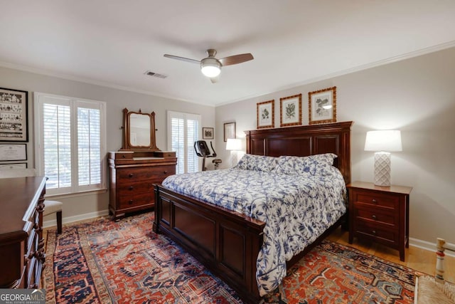 bedroom with ceiling fan and crown molding