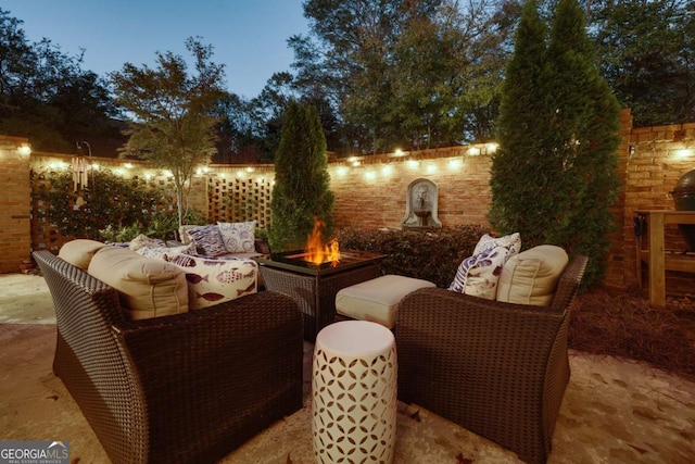 patio terrace at dusk featuring an outdoor fire pit