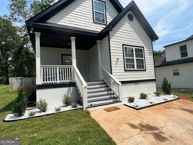 view of front of home with a front lawn and a porch