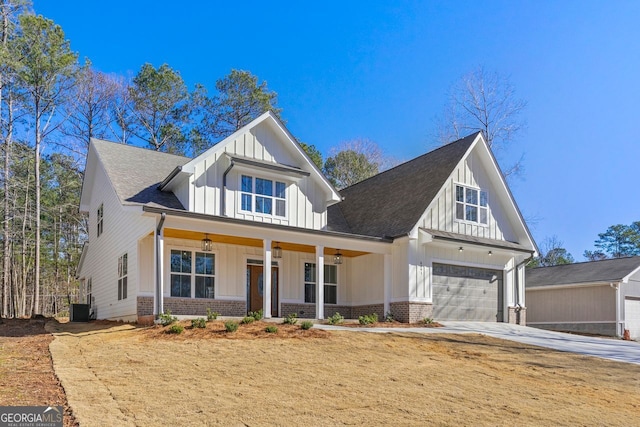 view of front of property with a garage, central AC unit, and a porch