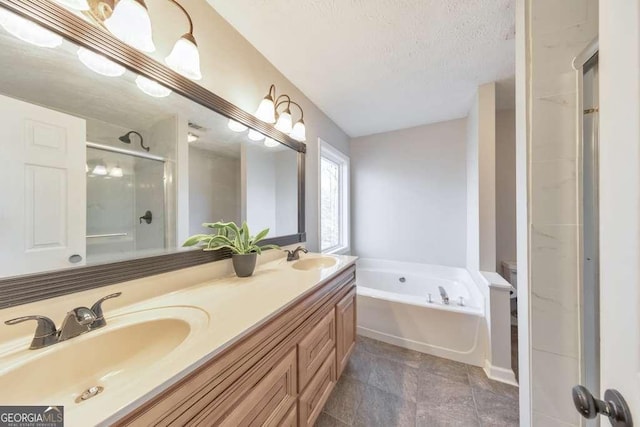 bathroom featuring a textured ceiling, vanity, and shower with separate bathtub