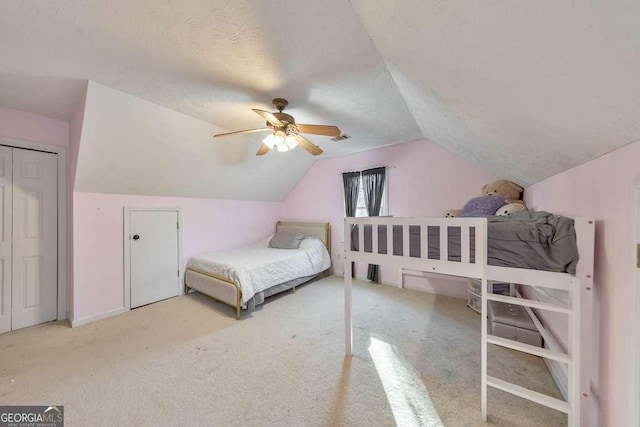 carpeted bedroom with vaulted ceiling and ceiling fan