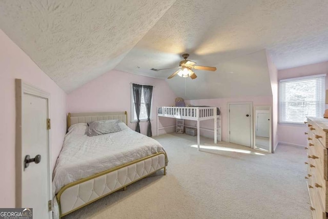 bedroom with ceiling fan, light carpet, a textured ceiling, and lofted ceiling