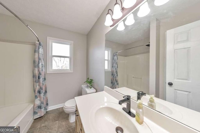 full bathroom featuring toilet, vanity, shower / bath combination with curtain, and a textured ceiling