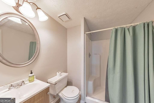 bathroom with a textured ceiling, toilet, vanity, and a shower with curtain