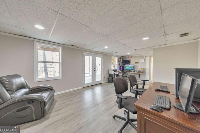 office with french doors, a paneled ceiling, and wood-type flooring