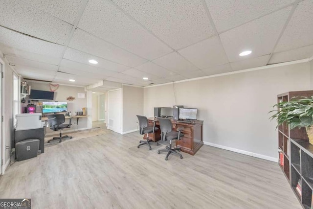 office space with wood-type flooring and a drop ceiling