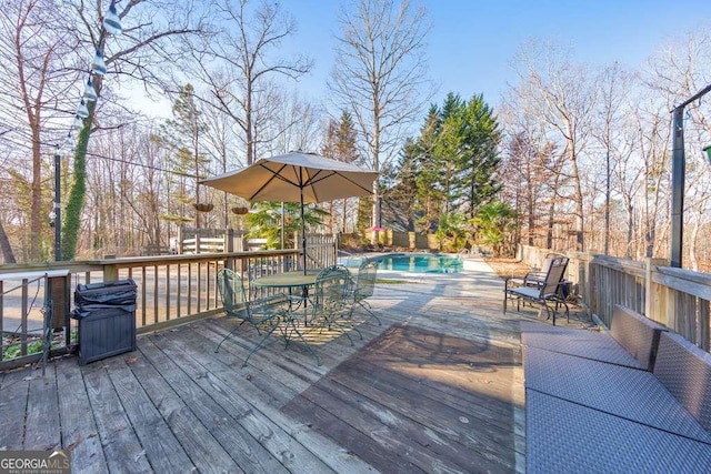 wooden deck featuring a fenced in pool