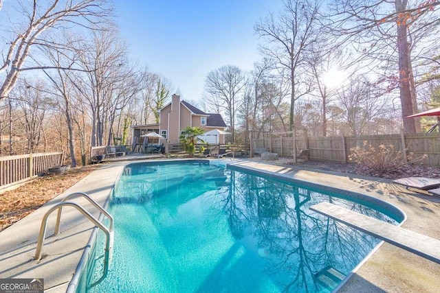 view of pool featuring a diving board