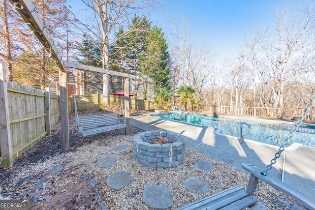 view of swimming pool with a fire pit