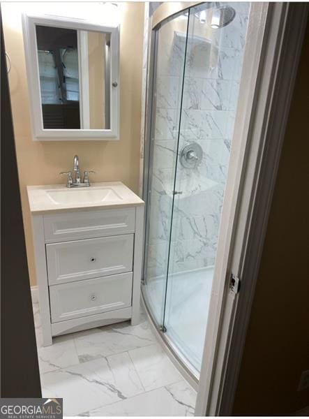 bathroom with vanity and a shower with door