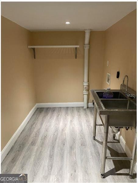 laundry room with sink, hookup for a washing machine, and hardwood / wood-style flooring